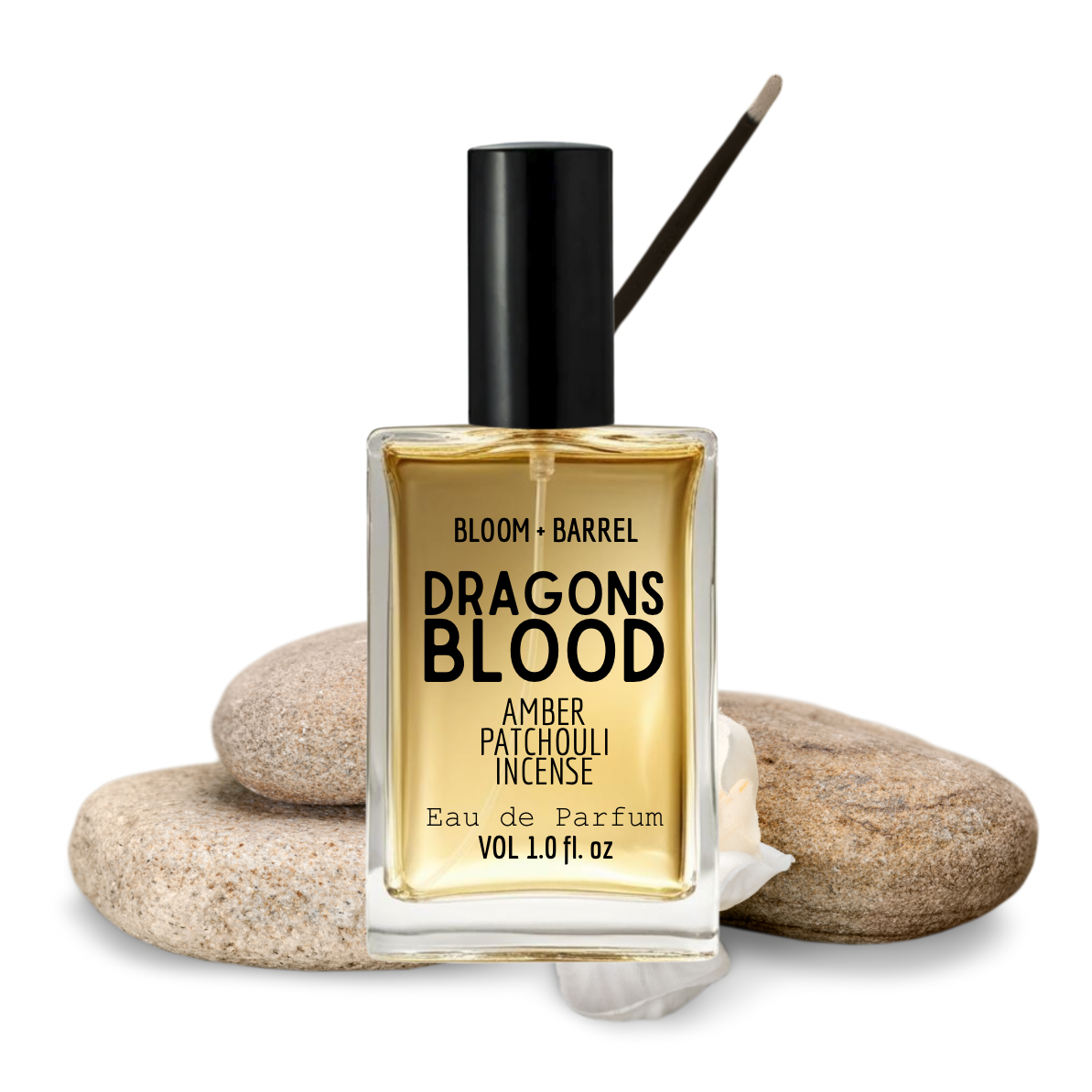 Bottle of 'Dragons Blood' amber patchouli incense eau de parfum by Bloom & Barrel on stones.