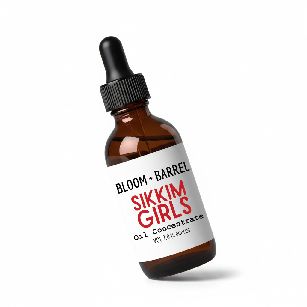 An amber glass dropper bottle with a black cap and a white label reading 'BLOOM + BARREL' and 'SIKKIM GIRLS Oil Concentrate' on a plain white background.