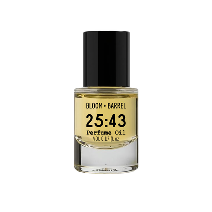 Perfume oil bottle with black cap and yellow label on a white background