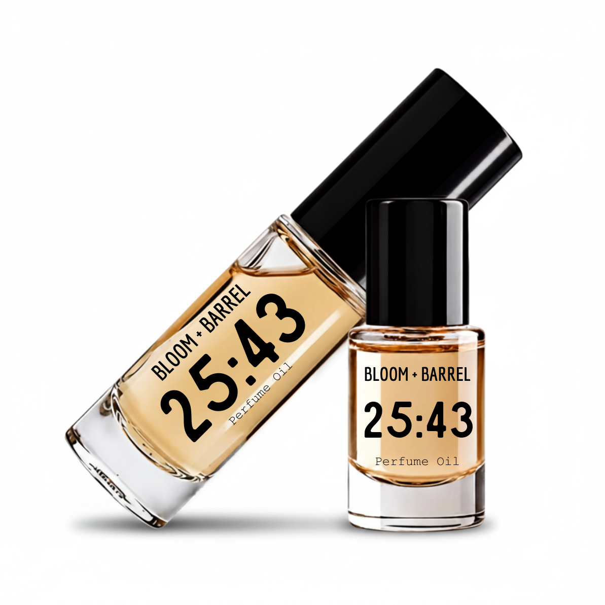 Two glass bottles of Bloom + Barrel 25:43 perfume oil with black caps, one standing upright and the other tilted diagonally, on a white background.