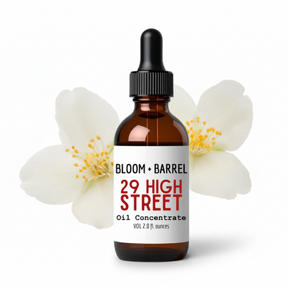 Bottle of '29 High Street' oil concentrate with a dropper surrounded by flowers on a white background