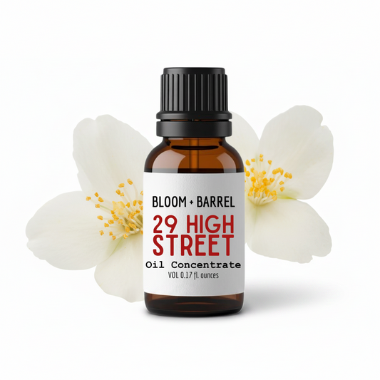 Bottle of '29 High Street' oil concentrate with flowers on a white background