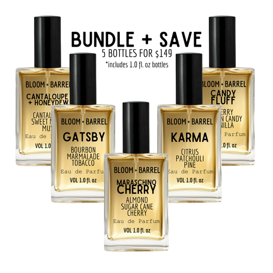 Five Bloom + Barrel perfume bottles arranged in a bundle with promotional text reading 'BUNDLE + SAVE' above them. The bottles contain amber-gold liquid and have black caps; visible scents include Cantaloupe + Honeydew, Gatsby, Karma, Maraschino Cherry, and Candy Fluff.