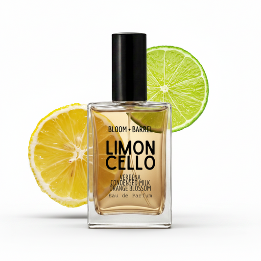 A bottle of Bloom + Barrel Limon Cello Eau de Parfum with a black cap, set against a white background with decorative lemon and lime slices.