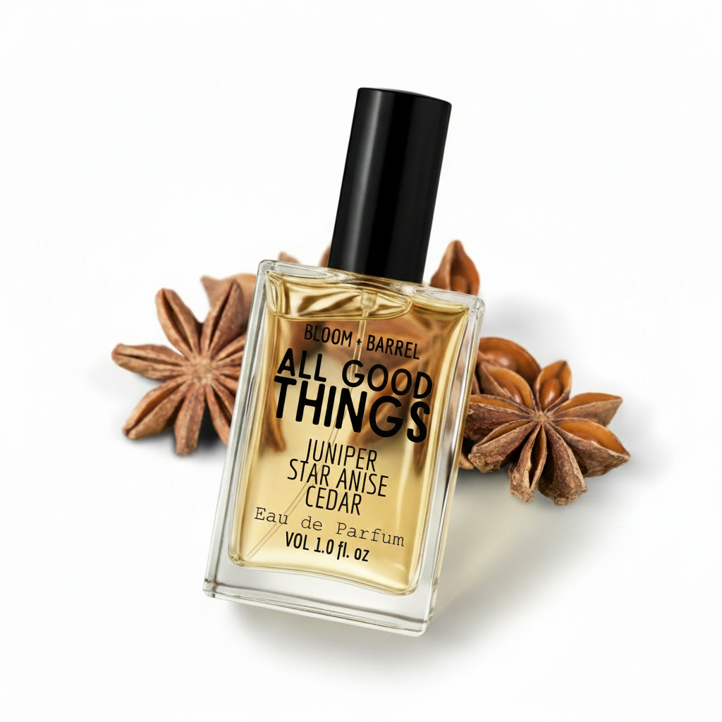 Perfume bottle labeled 'All Good Things' with star anise and juniper berries on a white background