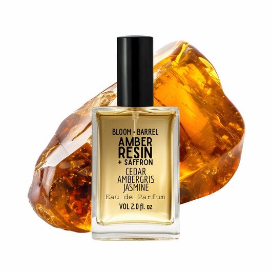 Perfume bottle with amber resin and saffron theme on a white background