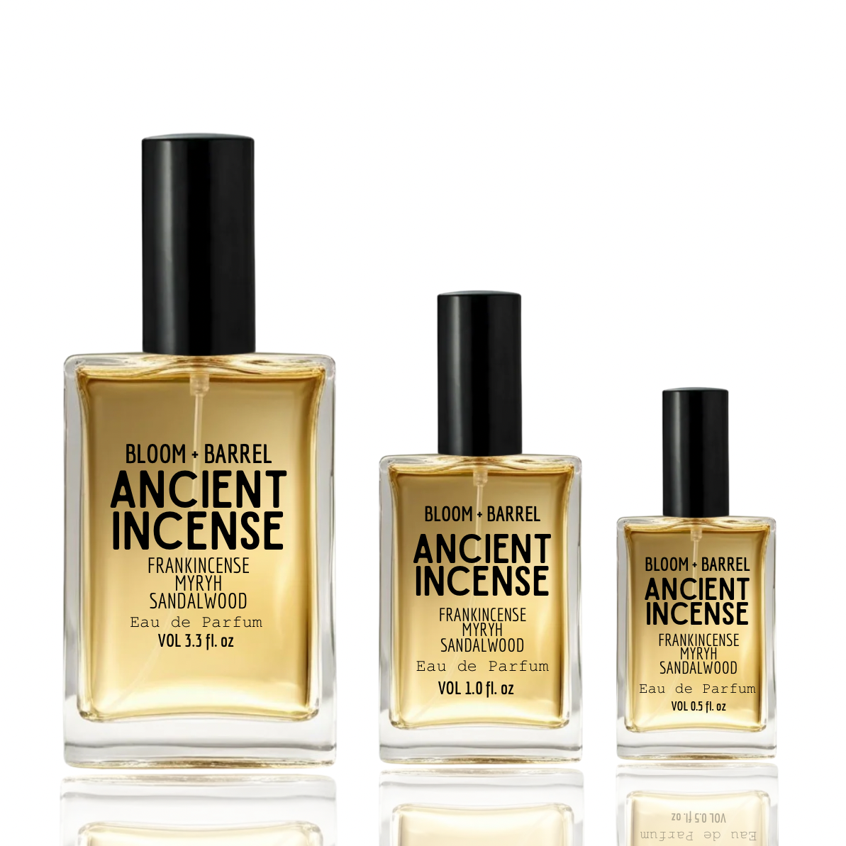 Three Bloom + Barrel Ancient Incense Eau de Parfum bottles in different sizes, filled with amber liquid and featuring black caps, arranged on a white reflective surface.
