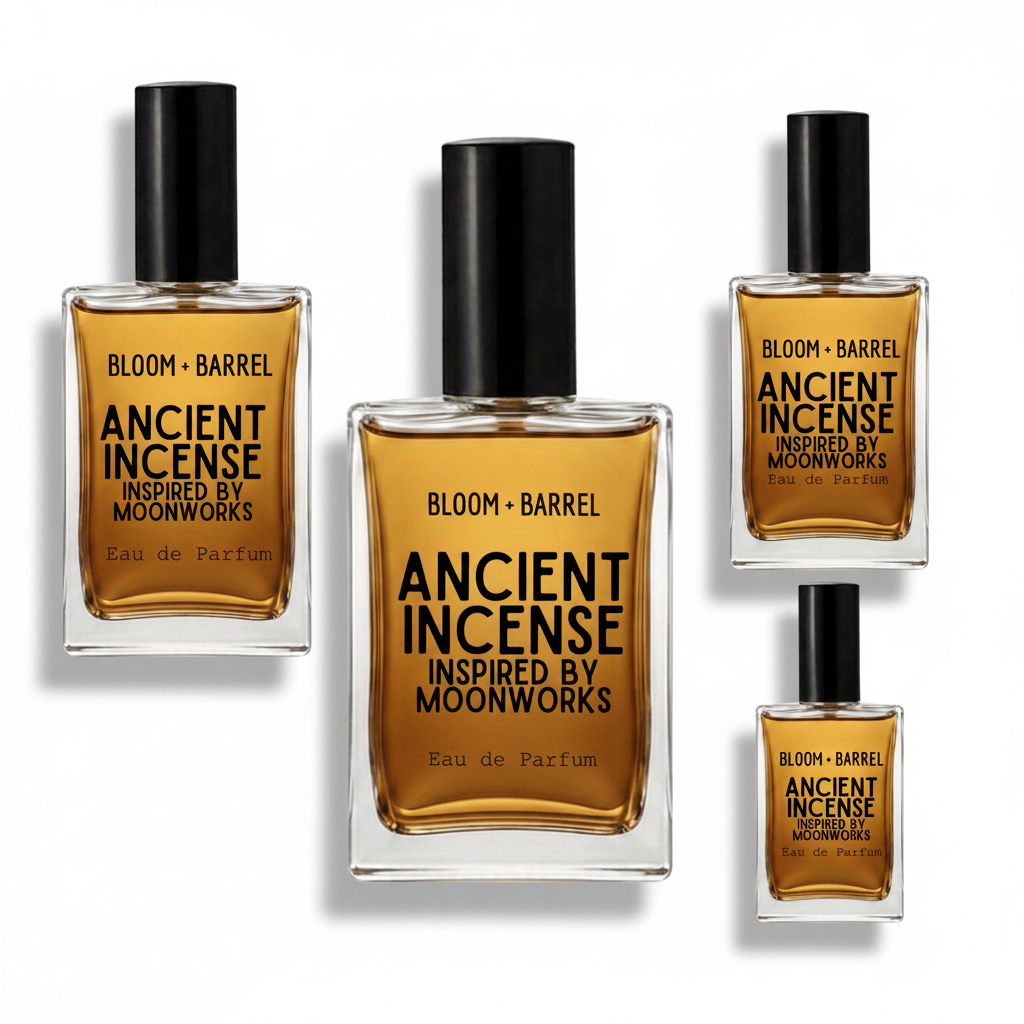 Four clear glass perfume bottles with black caps and amber liquid, arranged on a white background. The center bottle is largest, with three smaller bottles around it.