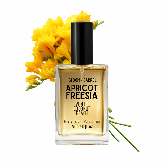 Perfume bottle labeled 'Apricot Freesia' with yellow flowers on a white background