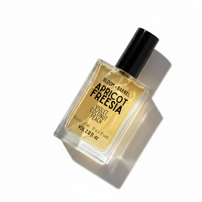 Perfume bottle labeled 'apricot freesia' by Bloom & Barrel on a white background