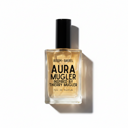 A rectangular glass bottle of Aura Mugler perfume with a black cap, filled with amber-colored liquid, on a plain white background.