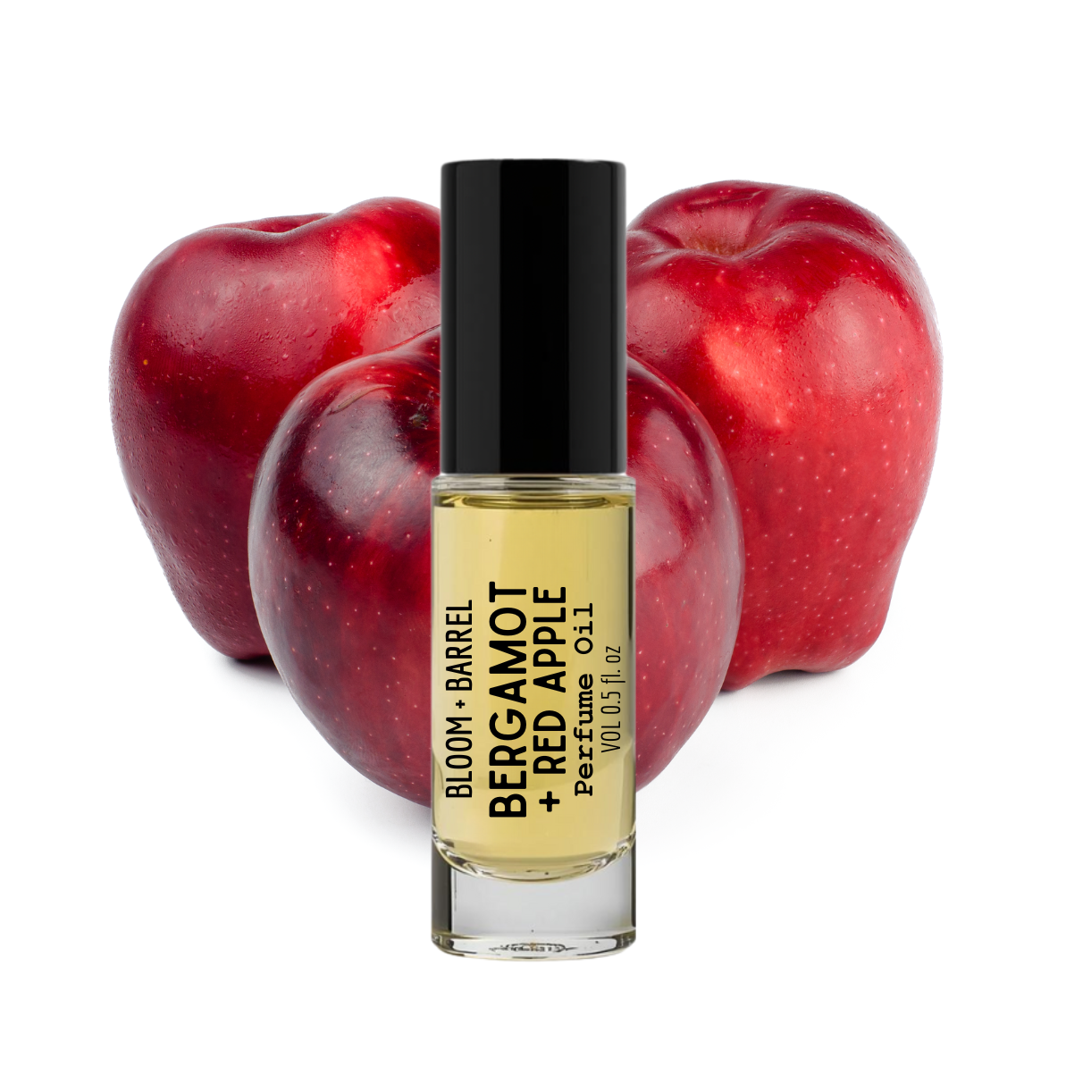 Perfume bottle labeled 'Bergamot + Barrel Bergamot + Red Apple' with red apples in the background