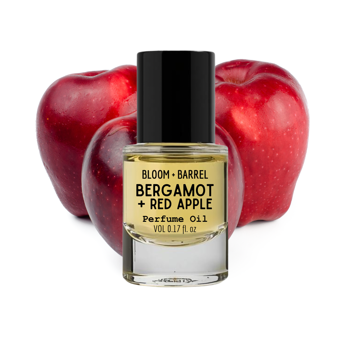 Perfume oil bottle labeled 'Bergamot + Red Apple' with three red apples in the background.