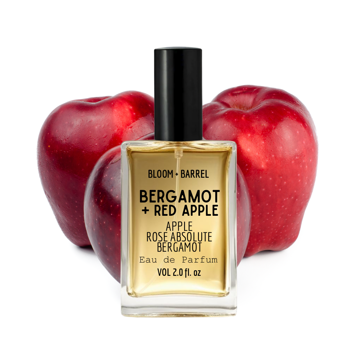 Perfume bottle labeled 'Bergamot + Red Apple' with two red apples on a white background