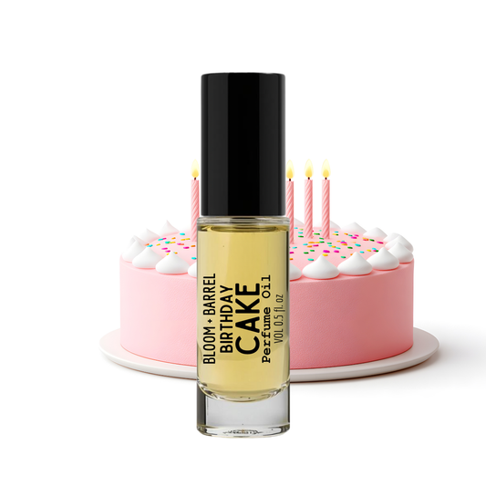 Perfume bottle labeled 'Birthday Cake' with a cake and candles in the background