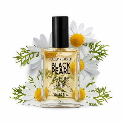 Perfume bottle labeled 'Black Pearl' with flowers on a white background