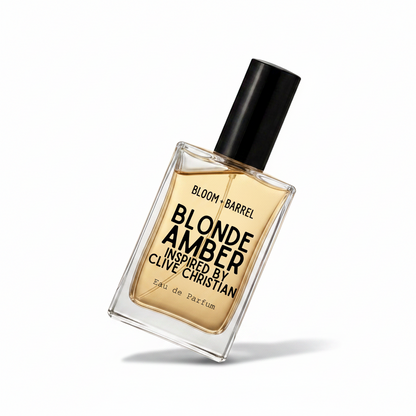 A rectangular glass bottle of Bloom Barrel Blonde Amber Eau de Parfum, filled with amber-colored liquid and featuring a black cap, centered on a plain white background.