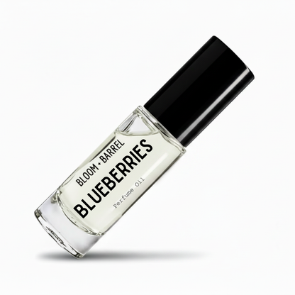 A clear glass perfume oil bottle with a black cap, labeled 'BLOOM • BARREL BLUEBERRIES Perfume Oil', shown on a clean white background with a soft shadow.