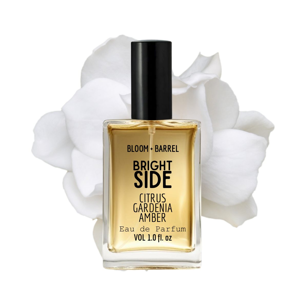 Perfume bottle labeled 'Bloom + Barrel Bright Side' with white flowers in the background