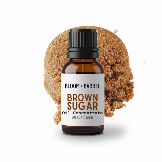 Bottle of Bloom & Barrel Brown Sugar Oil Concentrate with a piece of brown sugar on a white background