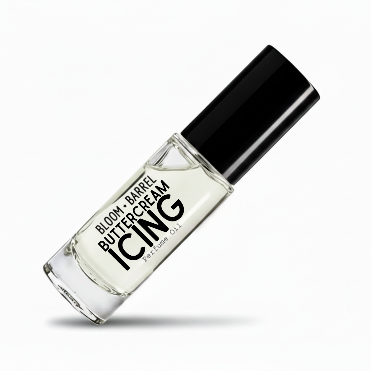 A clear glass perfume bottle with a black cap, labeled 'BLOOM + BARREL BUTTERCREAM ICING Perfume Oil', shown on a clean white background with a soft shadow.