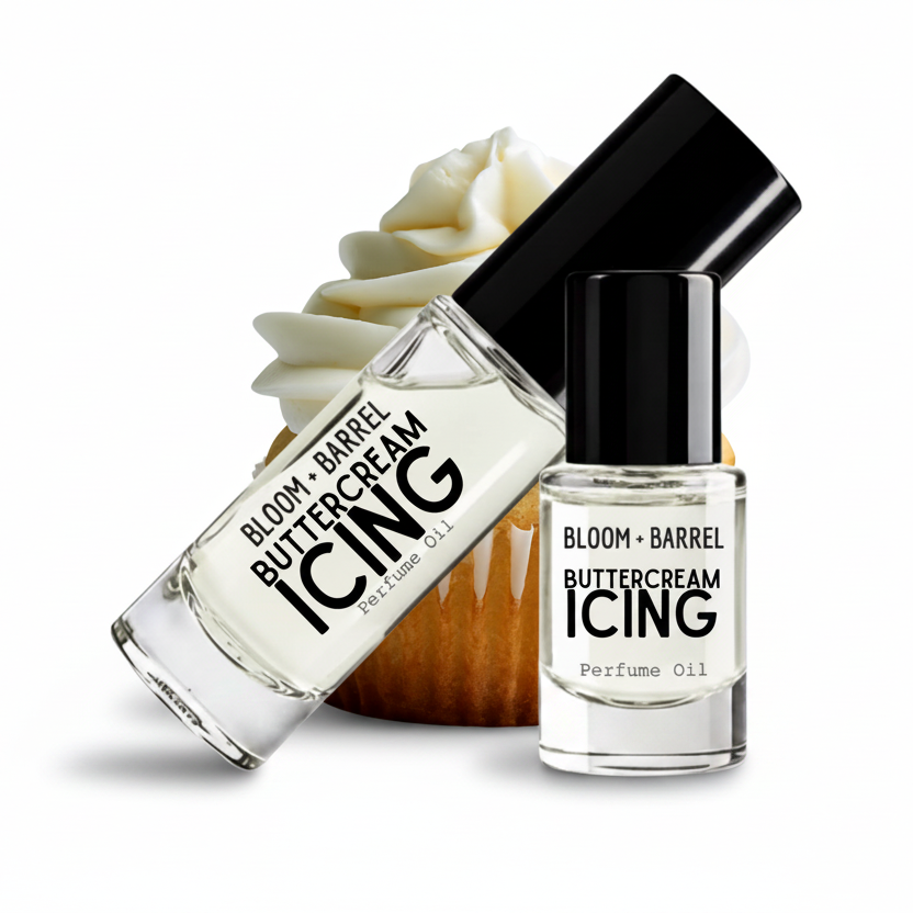 Two clear glass perfume oil bottles labeled BLOOM + BARREL Buttercream ICING Perfume Oil with black caps, shown on a white background with a cupcake decoration behind them.