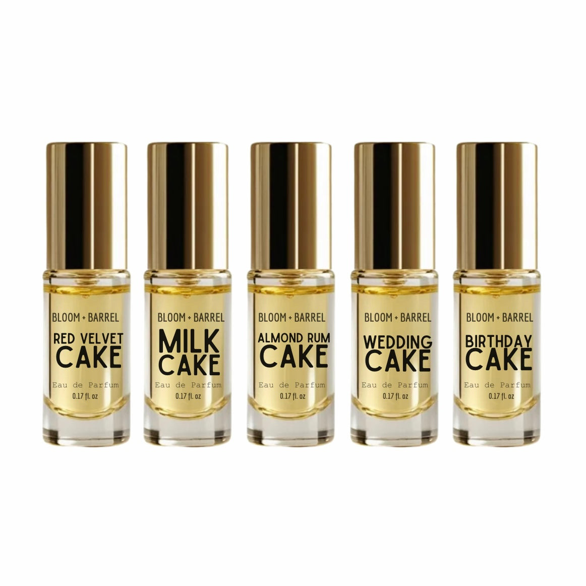 Six small Bloom + Barrel perfume sample bottles with metallic gold caps arranged in a row on a white background. The labels show different scent names: Red Velvet Cake, Milk Cake, Almond Rum Cake, Wedding Cake, and Birthday Cake.