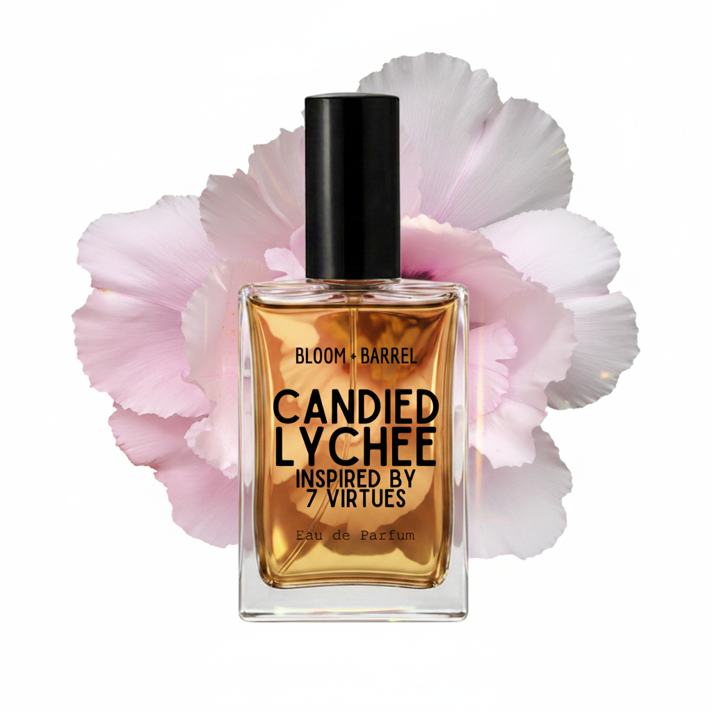 A rectangular glass perfume bottle with amber liquid and a black cap, centered in front of large pale pink flower petals on a white background. The bottle label reads 'BLOOM • BARREL', 'CANDIED LYCHEE', and 'INSPIRED BY 7 VIRTUES'.