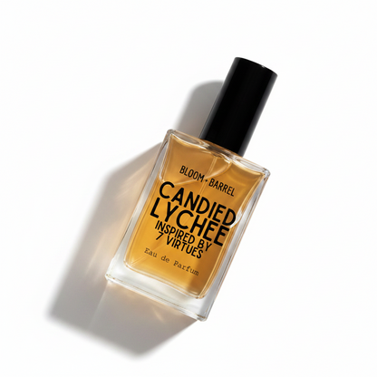 A rectangular glass bottle of Candied Lychee Eau de Parfum with amber-colored liquid, a black cap, and black text on the front, centered on a plain white background.
