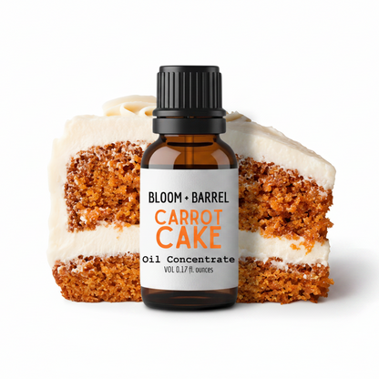 Bottle of Bloom & Barrel Carrot Cake oil concentrate with a slice of carrot cake on a white background