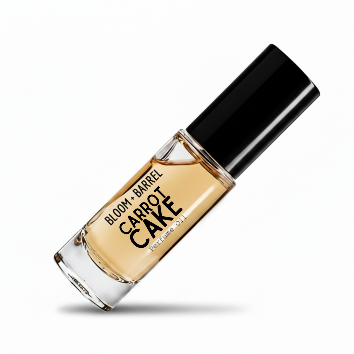 A glass bottle of Bloom Barrel carrot cake Perfume Oil with a black cap, filled with a golden-amber liquid, shown on a white background with a soft shadow.
