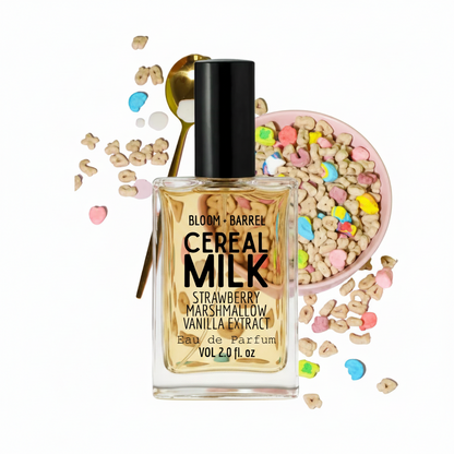 Bloom + Barrel Cereal Milk Strawberry Marshmallow Vanilla Extract Eau de Parfum in a clear rectangular bottle with a black cap, styled with cereal pieces, a spoon, and a bowl of colorful marshmallows on a white background.