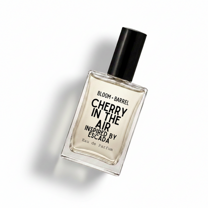 A rectangular glass bottle of Bloom Barrel Cherry in the Air Eau de Parfum with a black cap, centered on a plain white background.