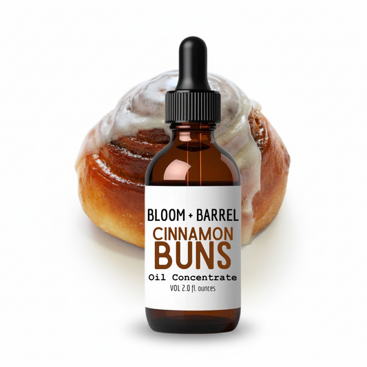 Bottle of 'Bloom + Barrel Cinnamon Buns' oil concentrate with a cinnamon bun in the background.