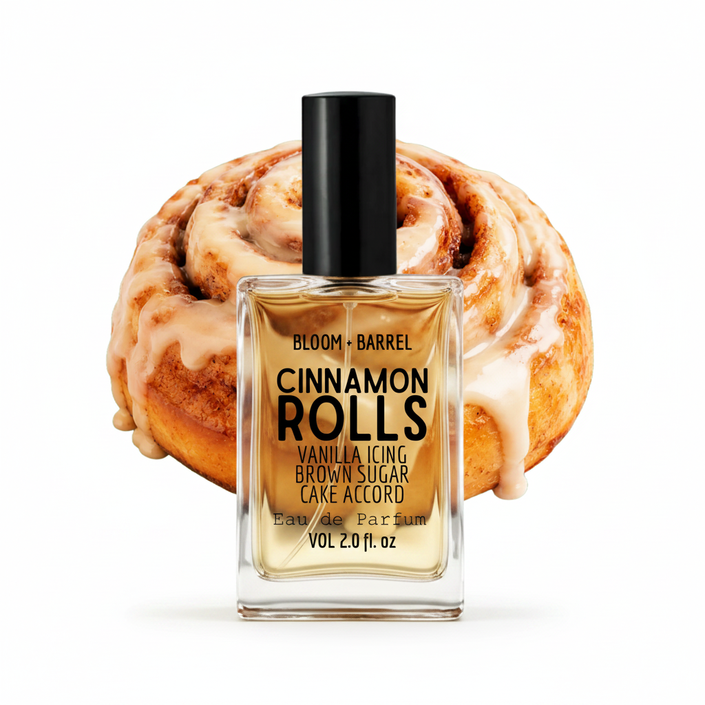 A bottle of Bloom + Barrel Cinnamon Rolls Eau de Parfum placed in front of a large cinnamon roll illustration on a black background. The clear glass bottle contains a warm golden-amber liquid and has a black cap.