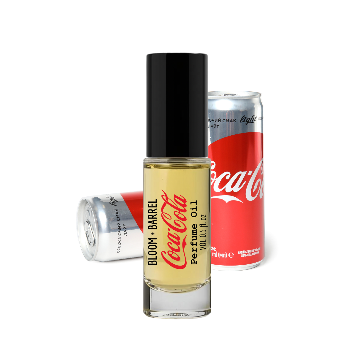 Coca-Cola Bloom Barrel perfume bottle with two cans on a white background