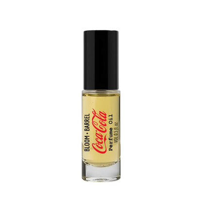 Perfume bottle labeled 'Bloom & Barrel Coca-Cola' on a white background