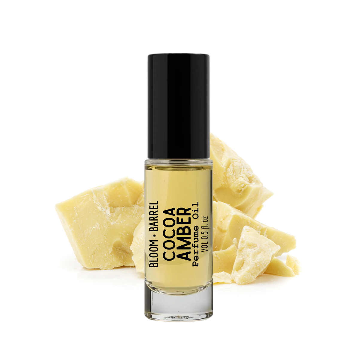 Perfume bottle labeled 'Cocoa Amber' by Bloom & Barrel with a piece of amber on a white background