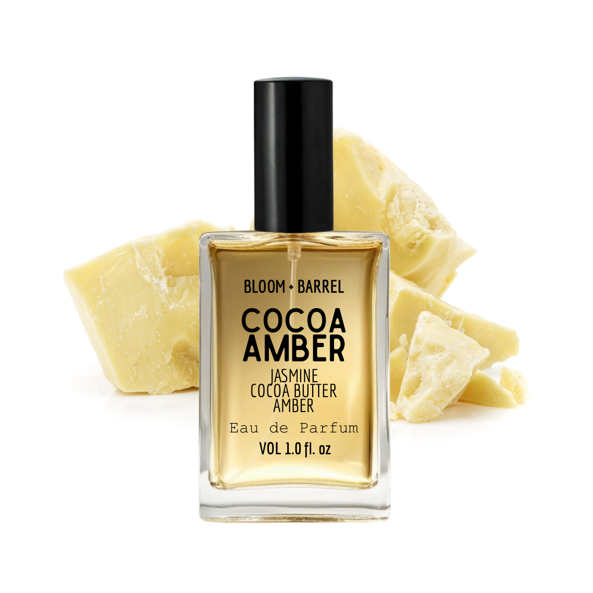 Perfume bottle labeled 'Cocoa Amber' with cocoa butter pieces on a white background