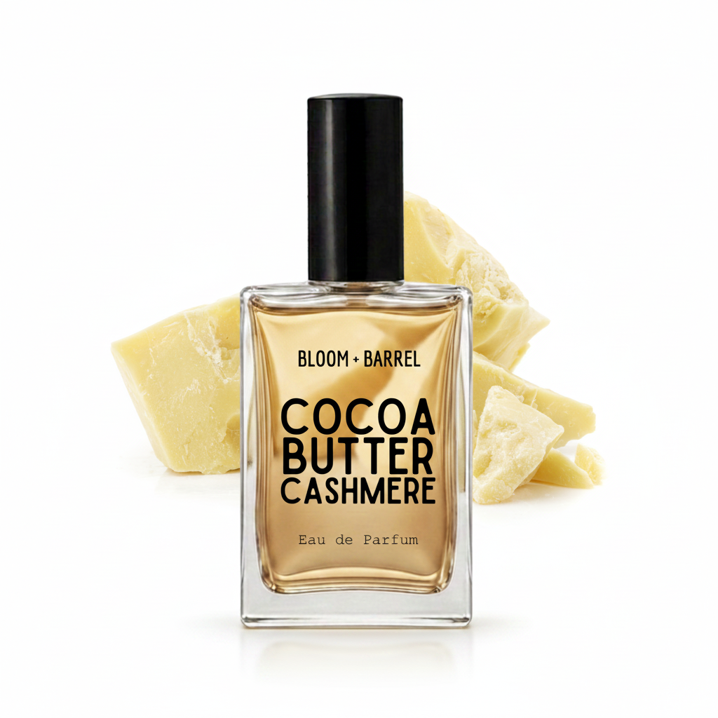 A bottle of Bloom Barrel Cocoa Butter Cashmere Eau de Parfum with a black cap, set against a white background with decorative cashmere wool chunks behind it.