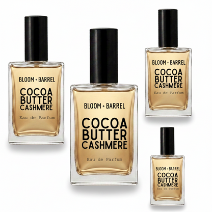 Four bottles of BLOOM + BARREL Cocoa Butter Cashmere Eau de Parfum in different sizes, arranged on a plain white background.