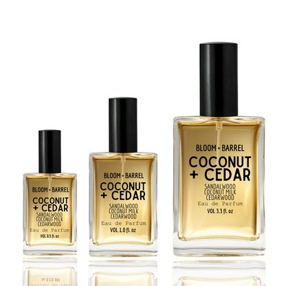 Three bottles of Bloom + Barrel Coconut + Cedar perfume on a white background