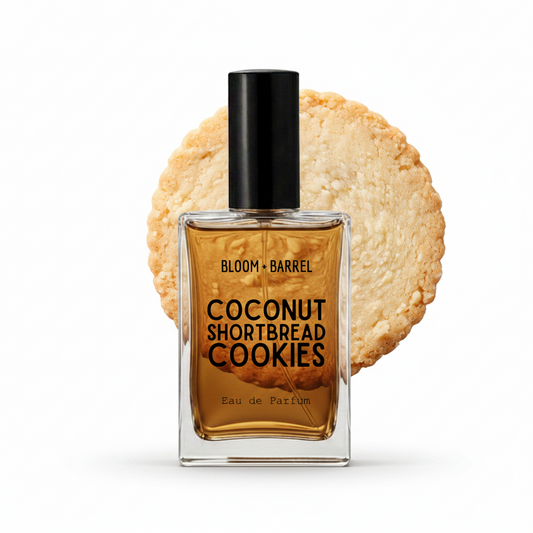 A perfume bottle labeled 'BLOOM • BARREL' and 'COCONUT SHORTBREAD COOKIES' stands in front of a round cookie graphic on a white background.