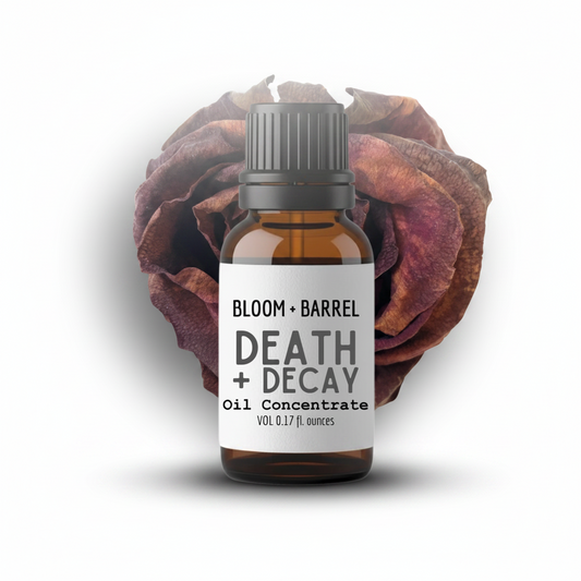 Bottle of Bloom & Barrel 'Death + Decay' oil concentrate with a dried flower on a white background
