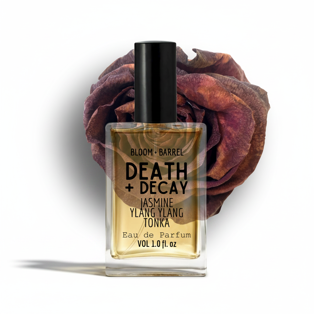Perfume bottle labeled 'Death + Decay' with a dried rose on a white background