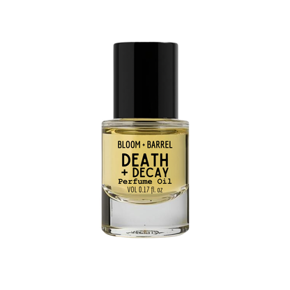 Perfume oil bottle labeled 'Death + Decay' by Bloom & Barrel on a white background