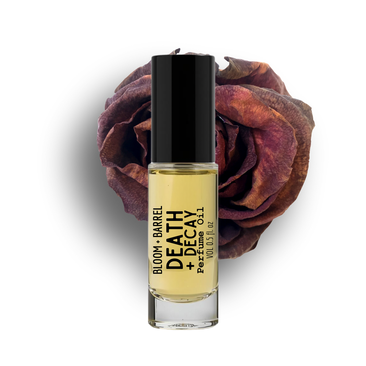 Perfume bottle labeled 'Death + Decay' by Bloom + Barrel with a dried rose on a white background