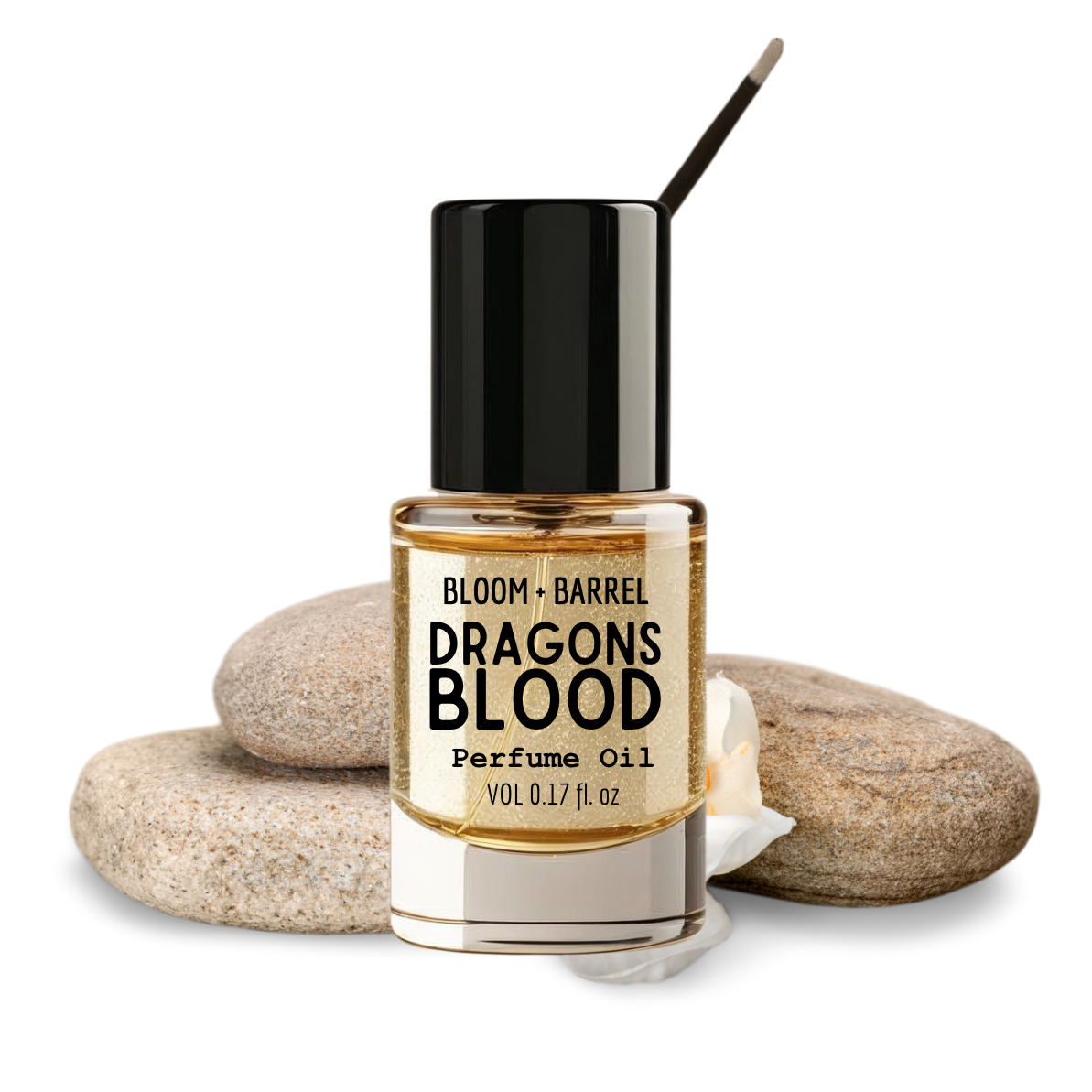 Bottle of Bloom & Barrel Dragons Blood perfume oil with rocks on a white background