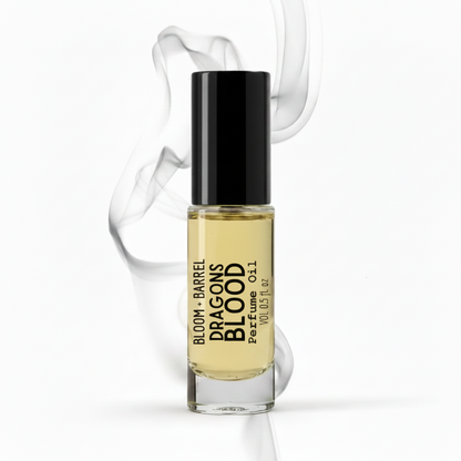 Perfume bottle labeled 'Bloom & Barrel Dragons Blood' with a black cap on a white background