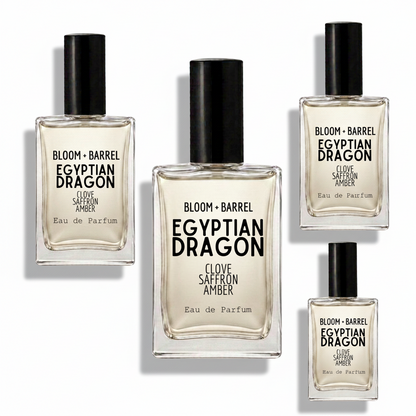 Four glass perfume bottles with black caps arranged on a white background, including the Bloom + Barrel Karma Inspired by Lush Eau de Parfum in different sizes.